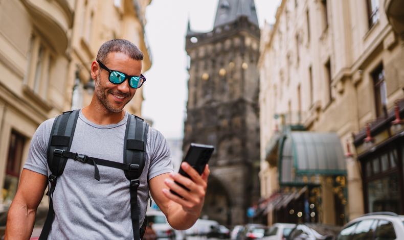 Man using digital banking while traveling