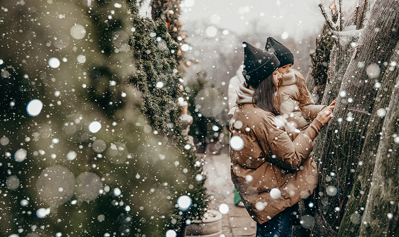 mother and daughter shopping for a christmas tree